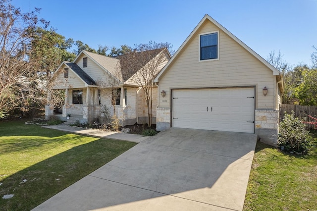 view of front facade with covered porch, a front yard, fence, stone siding, and driveway