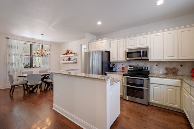 kitchen with stainless steel appliances, decorative backsplash, dark wood finished floors, and a center island