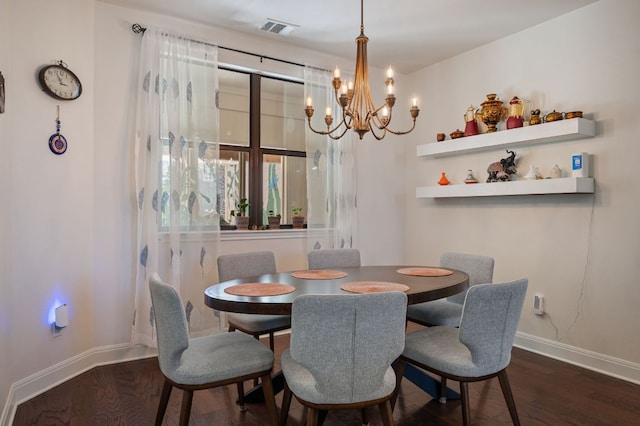 dining room featuring baseboards, visible vents, and wood finished floors