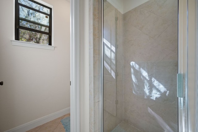 bathroom with baseboards, a stall shower, and tile patterned floors