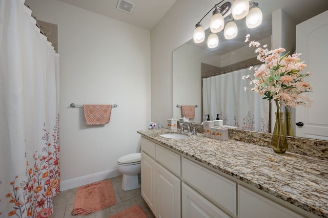 bathroom with visible vents, toilet, vanity, tile patterned flooring, and baseboards