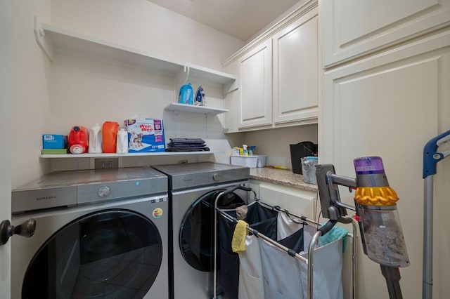 laundry room with cabinet space and washing machine and clothes dryer