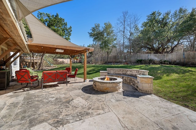 view of patio with a fenced backyard and a fire pit