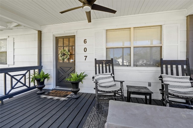 entrance to property with ceiling fan and a porch