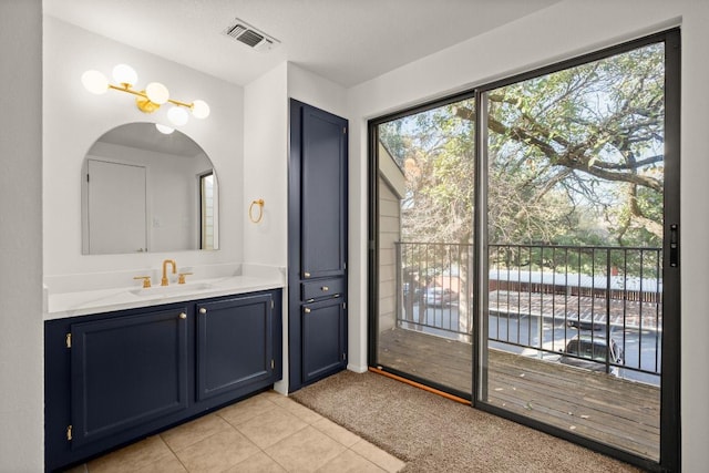 bathroom with vanity, tile patterned flooring, and visible vents