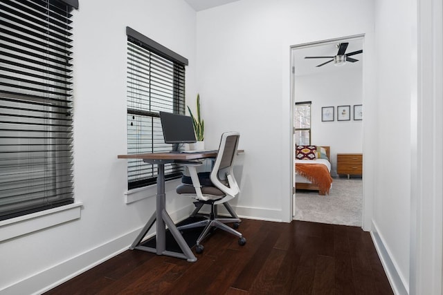 office space with dark wood-type flooring, ceiling fan, and baseboards