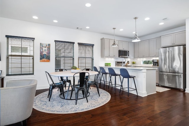 dining area featuring dark wood-style flooring, plenty of natural light, and recessed lighting