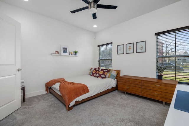 bedroom with light carpet, ceiling fan, baseboards, and recessed lighting