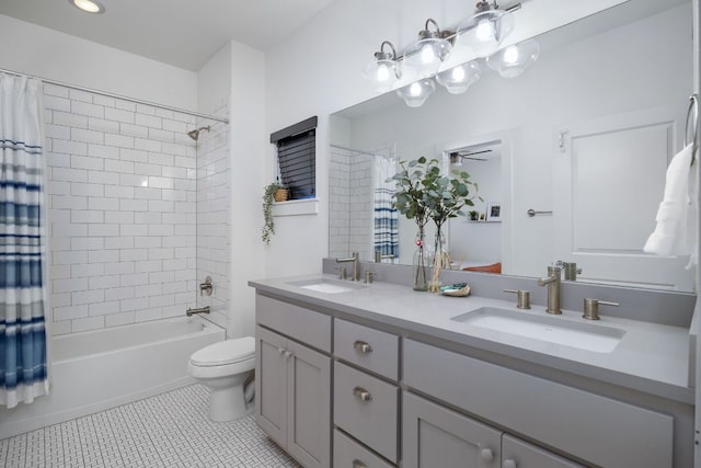 full bath with tile patterned flooring, a sink, toilet, and shower / bath combo