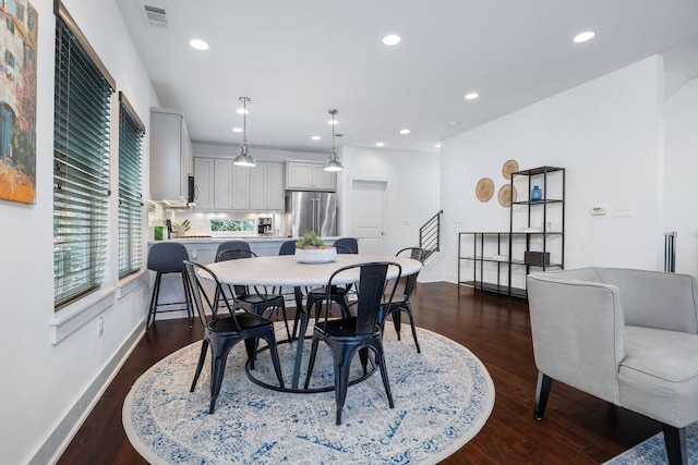 dining room featuring recessed lighting, dark wood-style flooring, visible vents, baseboards, and stairway