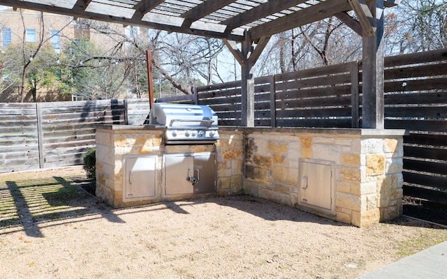 view of patio / terrace with a fenced backyard, a pergola, and area for grilling