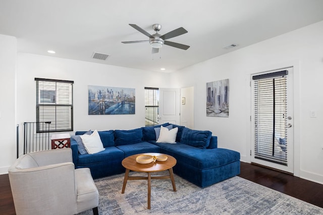 living area featuring dark wood-type flooring, recessed lighting, visible vents, and a healthy amount of sunlight