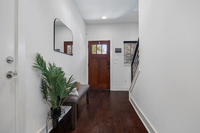 doorway to outside with dark wood-type flooring and baseboards