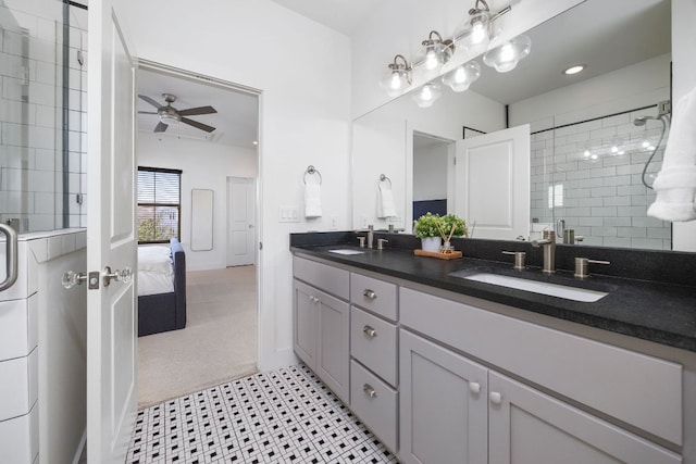 full bathroom with a ceiling fan, a stall shower, a sink, and connected bathroom