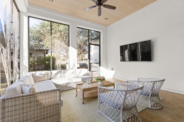 sunroom / solarium featuring a ceiling fan, wood ceiling, and a healthy amount of sunlight