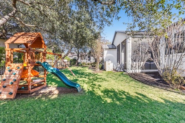 view of play area featuring fence and a lawn