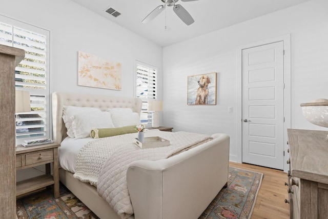 bedroom with visible vents, ceiling fan, and light wood-style flooring