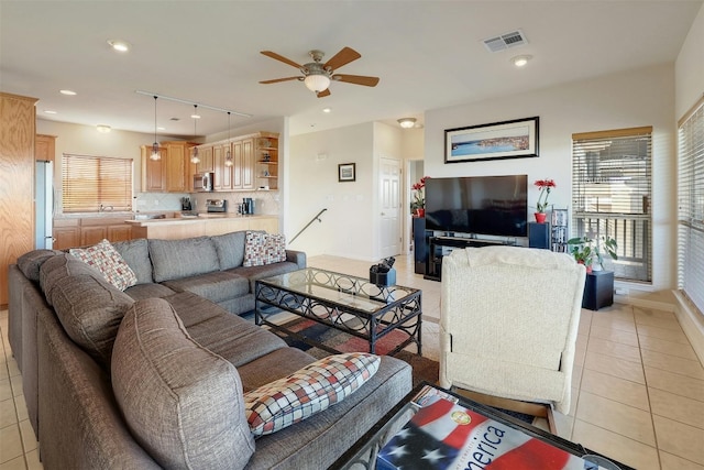 living area with light tile patterned floors, visible vents, baseboards, ceiling fan, and recessed lighting