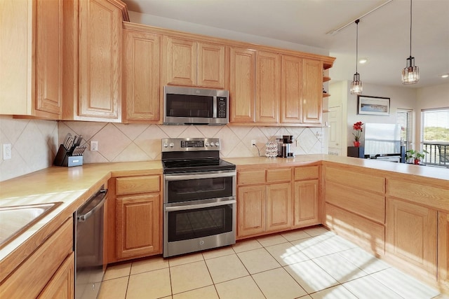 2802 Truman Cv, Lago Vista, TX 78645 - kitchen featuring appliances with stainless steel finishes, light countertops, light brown cabinetry, backsplash, and light tile patterned floors