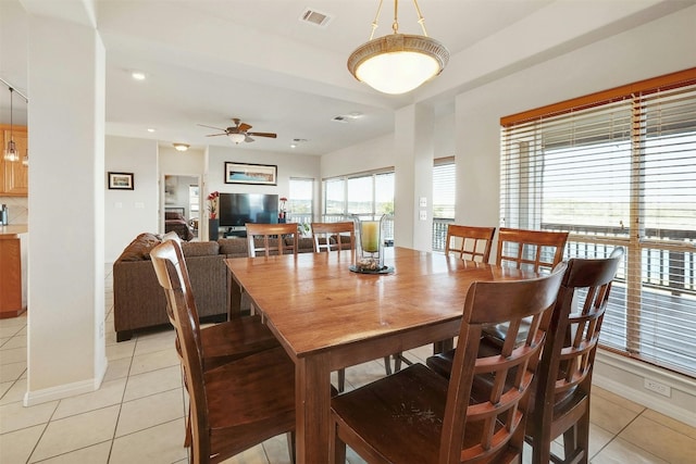 dining area featuring light tile patterned floors, baseboards, visible vents, and a ceiling fan