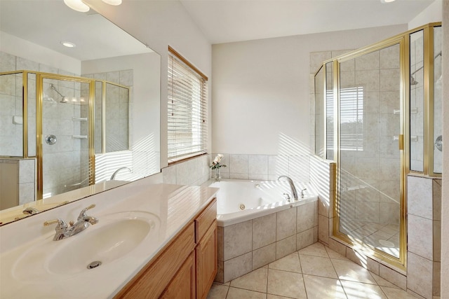 bathroom featuring a stall shower, tile patterned flooring, vanity, and a tub with jets