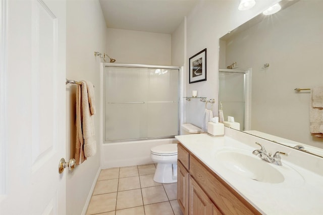 full bathroom featuring toilet, vanity, combined bath / shower with glass door, and tile patterned floors