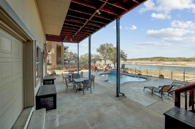 view of patio / terrace featuring a fenced in pool, outdoor dining space, a water view, and fence