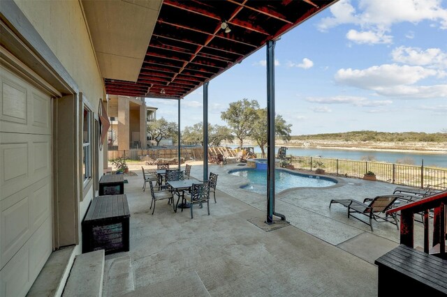 2802 Truman Cv, Lago Vista, TX 78645 - fenced backyard featuring a water view, a patio area, a pool with connected hot tub, and outdoor dining space
