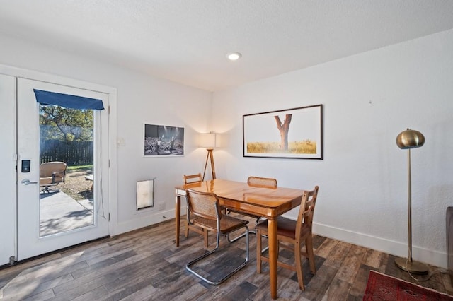 dining room featuring dark wood-type flooring, recessed lighting, and baseboards