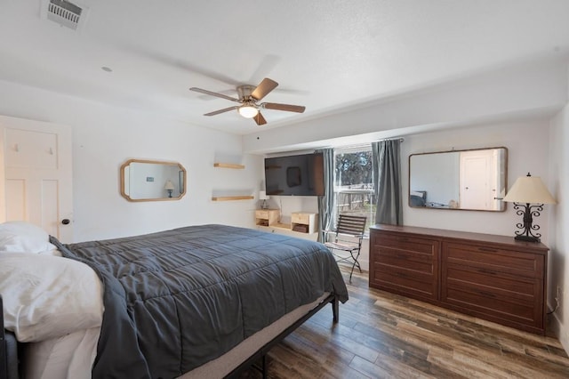 bedroom with access to exterior, a ceiling fan, visible vents, and wood finished floors