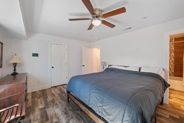 bedroom featuring a ceiling fan, visible vents, baseboards, and wood finished floors