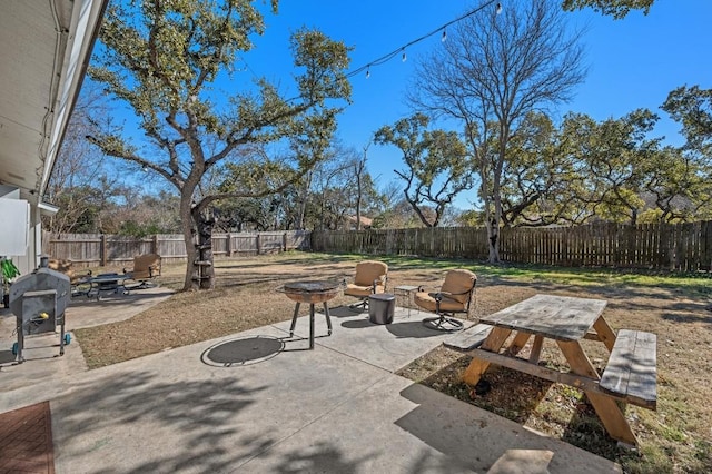 view of patio / terrace featuring an outdoor fire pit and a fenced backyard