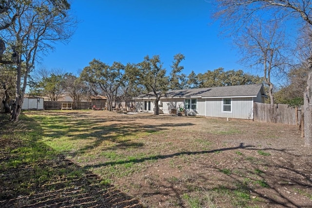 exterior space featuring fence, an outdoor structure, and a shed