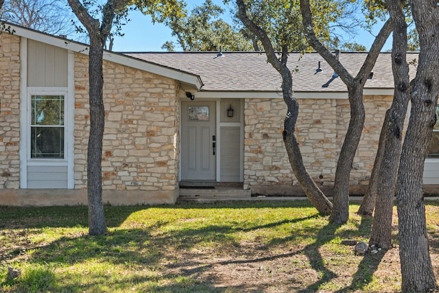 712 Ruby Isle Dr, Leander, TX 78641 - view of front of property featuring stone siding, a front lawn, and a shingled roof