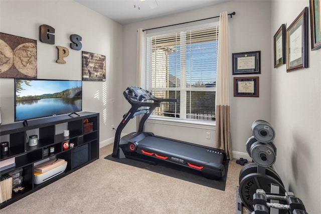 workout area featuring carpet flooring and baseboards