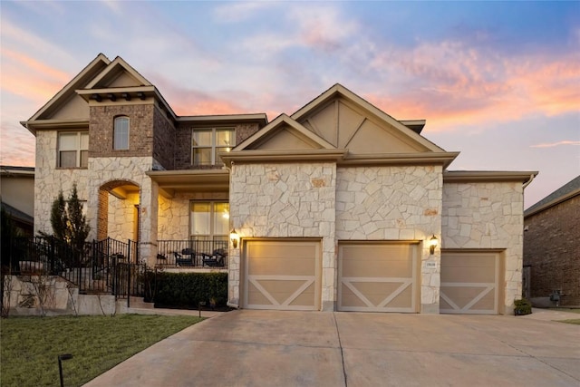 view of front of house with driveway and stone siding