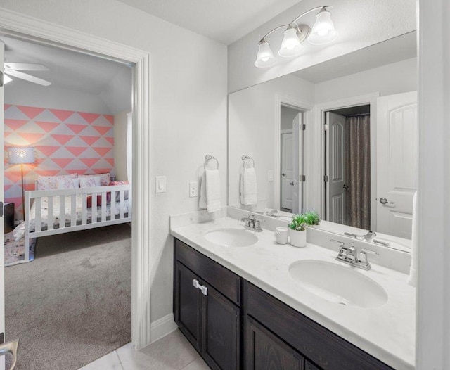 full bath featuring a ceiling fan, double vanity, a sink, and ensuite bathroom