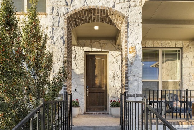 property entrance with stone siding