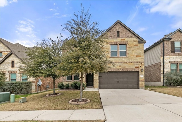 traditional-style house with a garage, stone siding, concrete driveway, and brick siding