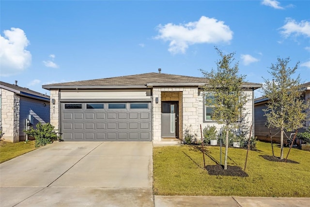 view of front of property with concrete driveway, a front lawn, and an attached garage