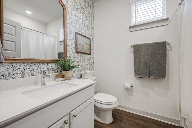 full bathroom featuring baseboards, vanity, toilet, and wood finished floors