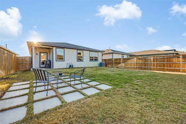 back of property featuring a patio area, a fenced backyard, cooling unit, and a yard