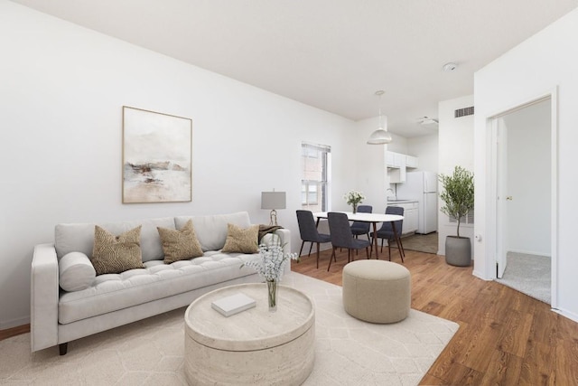 12166 Metric Blvd Unit 230, Austin, TX 78758 - living room featuring light wood-style floors and baseboards