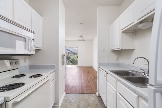 12166 Metric Blvd Unit 230, Austin, TX 78758 - kitchen featuring white appliances, white cabinetry, light countertops, and pendant lighting