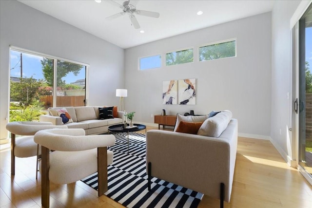 living room with ceiling fan, light wood finished floors, recessed lighting, and baseboards