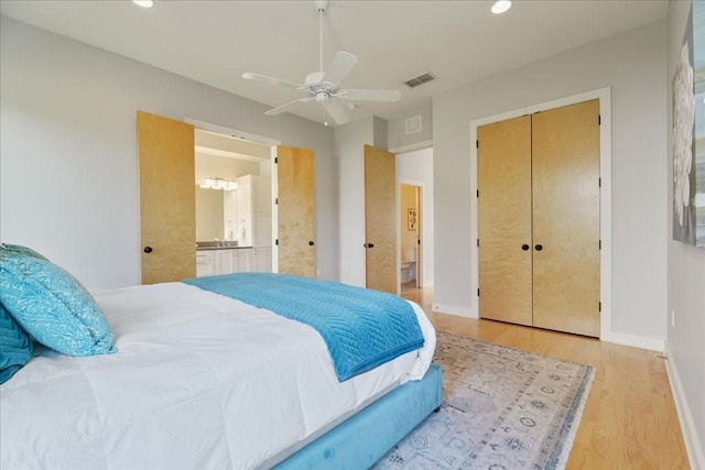 bedroom with recessed lighting, visible vents, ensuite bathroom, light wood-style floors, and baseboards