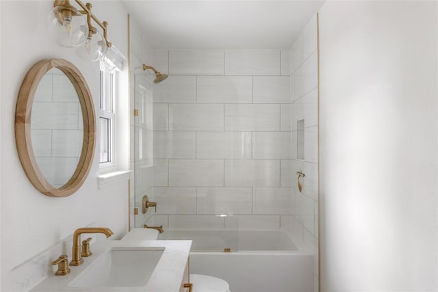 full bathroom featuring washtub / shower combination, vanity, and toilet