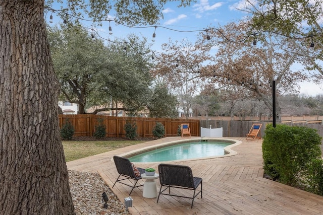 view of swimming pool with a fenced in pool, a fenced backyard, and a deck