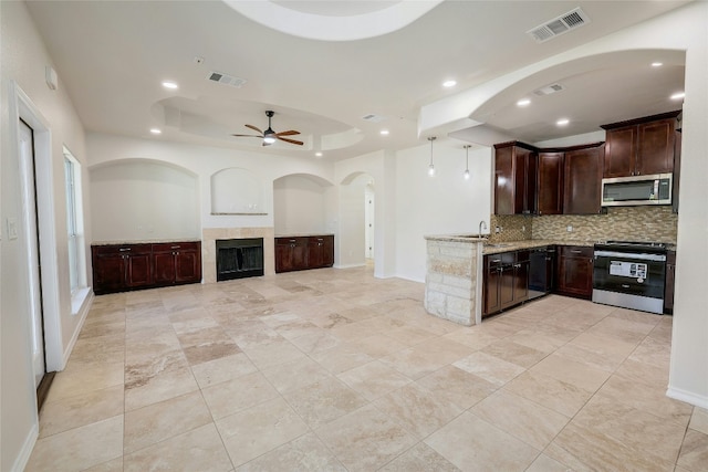 kitchen featuring visible vents, stainless steel microwave, tasteful backsplash, and electric range oven