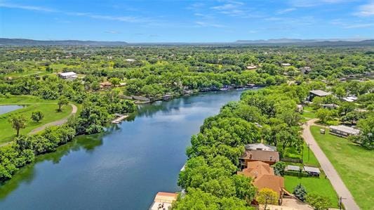 birds eye view of property featuring a water view and a view of trees